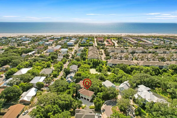 an aerial view of a houses with a yard