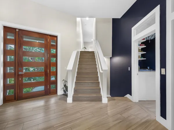 a view of an entryway with wooden floor
