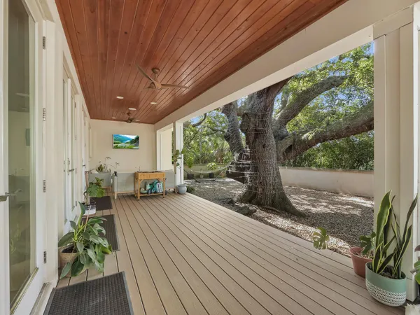 a view of a house with backyard sitting area and garden