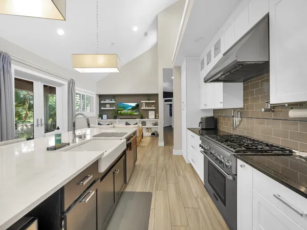 a kitchen with stainless steel appliances a stove and cabinets