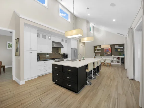 a kitchen with stainless steel appliances a sink a stove and cabinets
