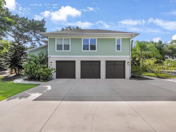 a front view of a house with a garden and yard