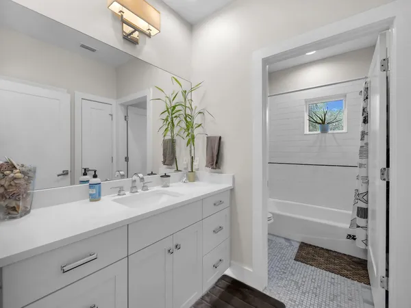 a bathroom with a double vanity sink and a mirror