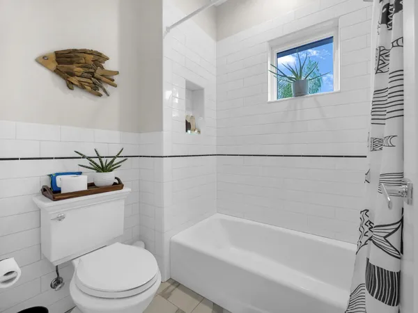 a bathroom with a toilet a sink and bathtub