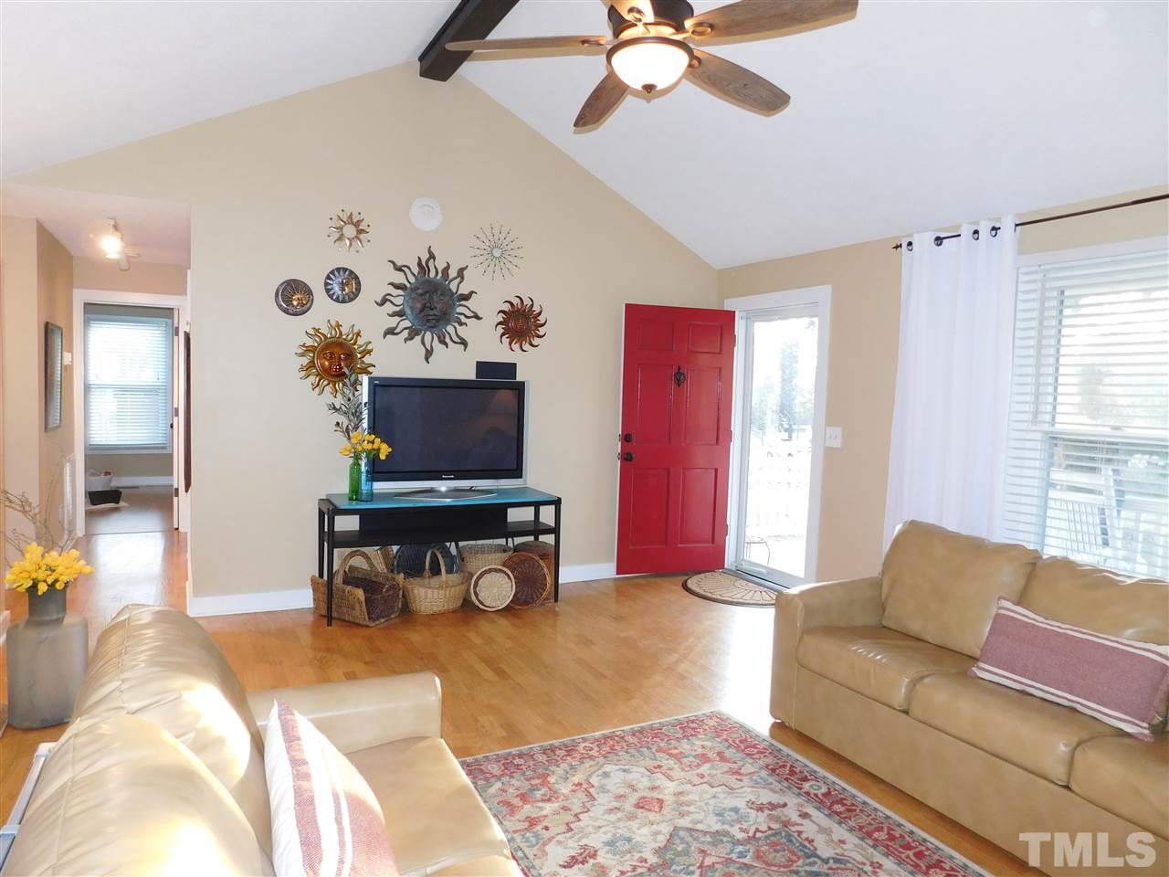 5217 Carrier Way Raleigh, NC 27603 - Photo 3 of 18 Tastefully refurbished family room with cathedral ceiling and hardwood floors.