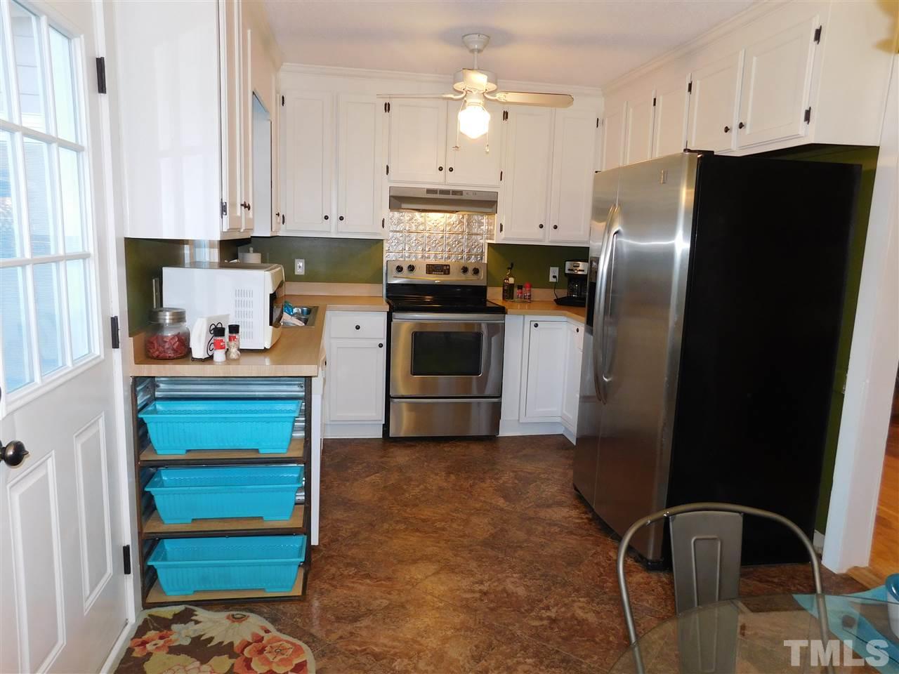 5217 Carrier Way Raleigh, NC 27603 - Photo 4 of 18 Eat-in kitchen opens to newly rebuilt deck/outdoor living area.