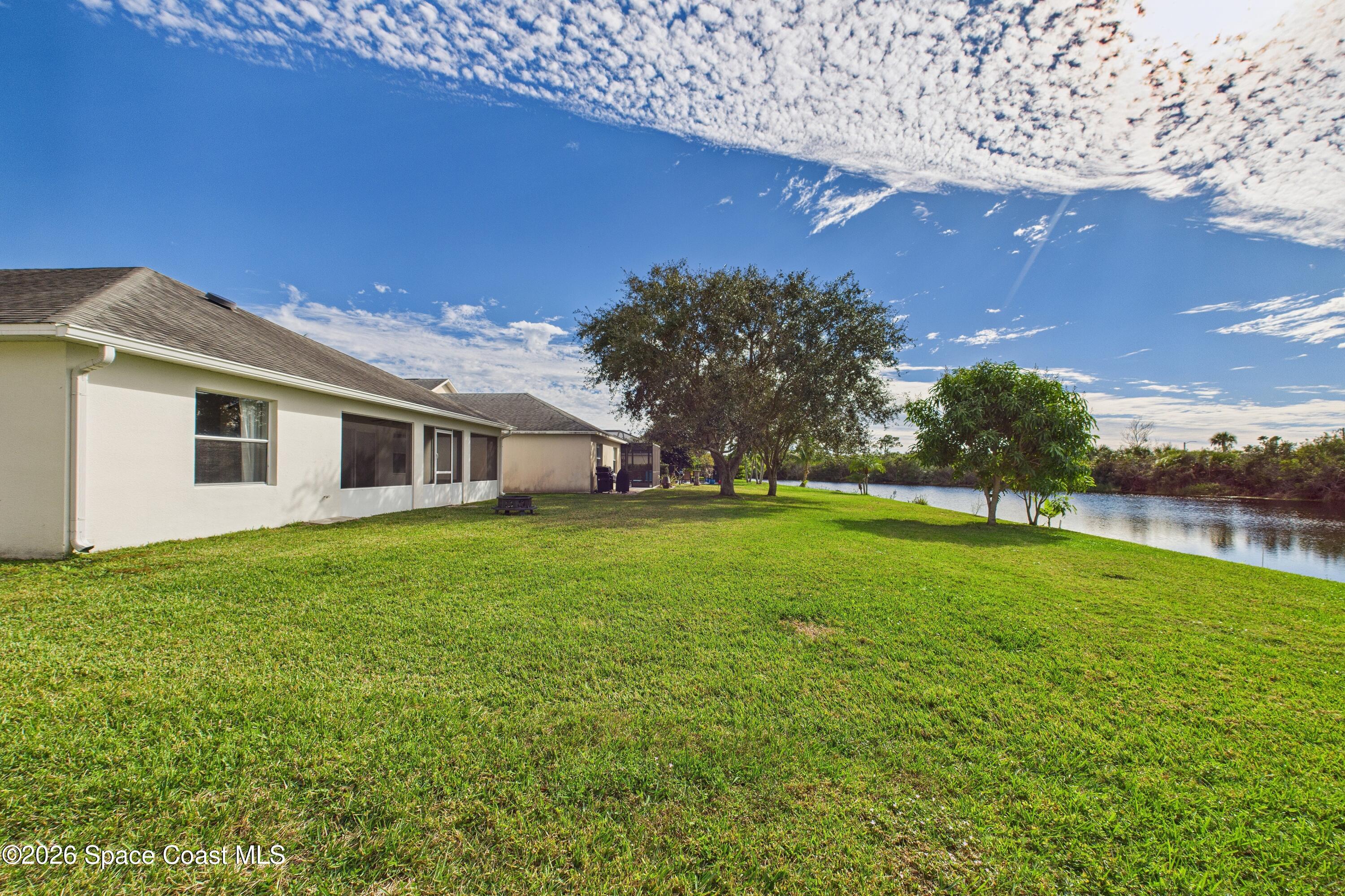 5251 Somerville Drive Rockledge, FL 32955 - Photo 54 of 71 a front view of a house with garden