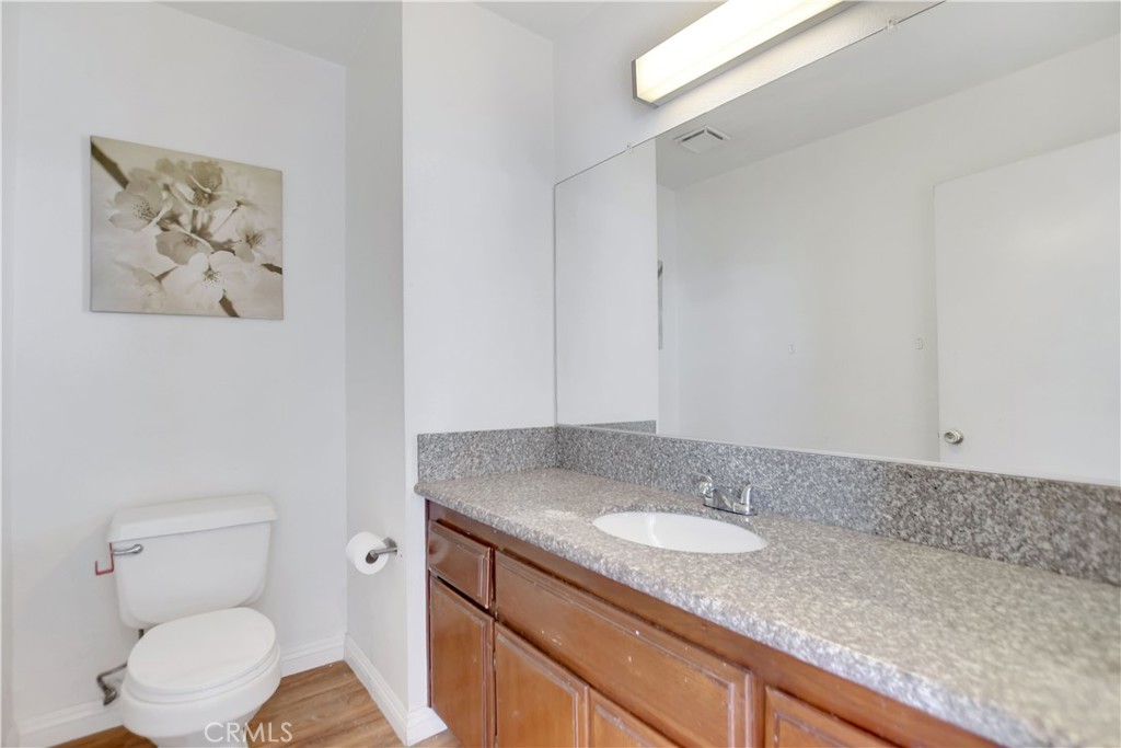 14527 Pony Trail Road Victorville, CA 92392 - Photo 13 of 21 a bathroom with a granite countertop sink mirror vanity and toilet