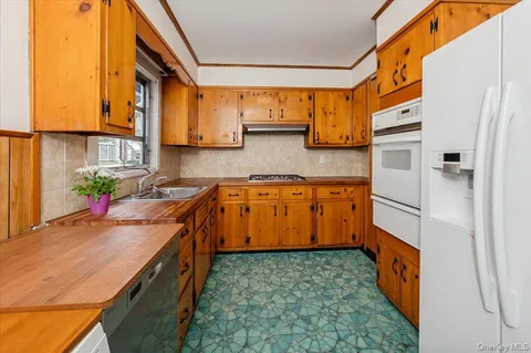 a kitchen with stainless steel appliances a sink and a refrigerator