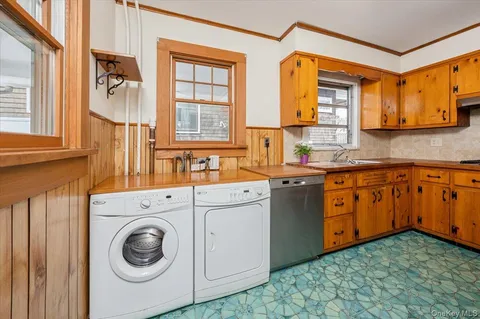 a kitchen with a sink cabinets and a window