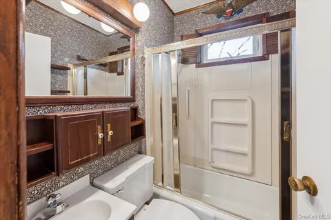 a bathroom with a toilet a sink and shower