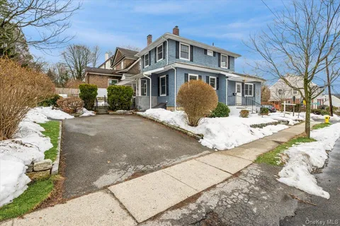 a front view of a building with a yard