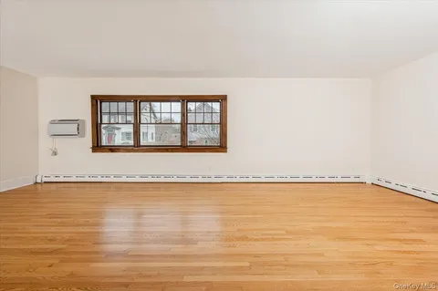 a view of a room with an empty space and a window