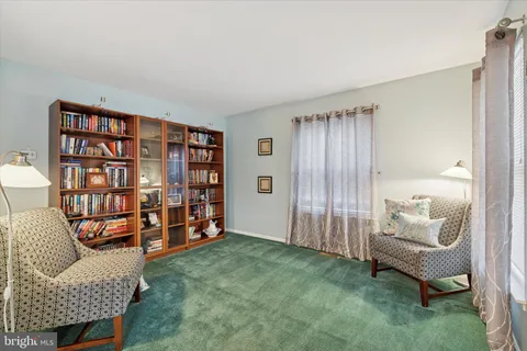 a living room with furniture and a chair