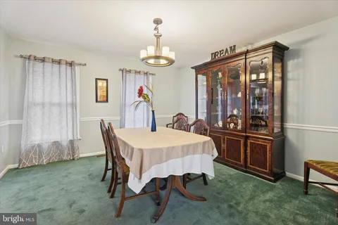 a bedroom with a bed a couch and a chandelier