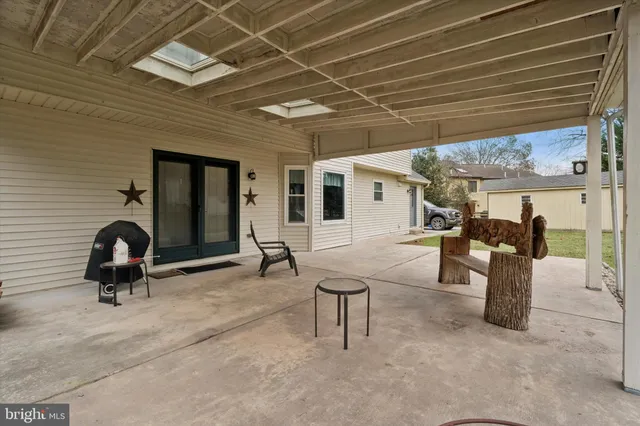 a view of a patio with table and chairs and potted plants