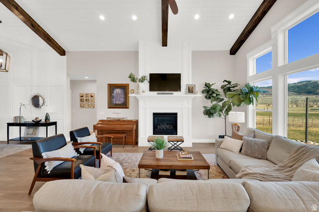 352 East Boulderville Road Oakley, UT 84055 - Photo 9 of 62 Living area with a glass covered fireplace, recessed lighting, wood finished floors, and vaulted ceiling with beams