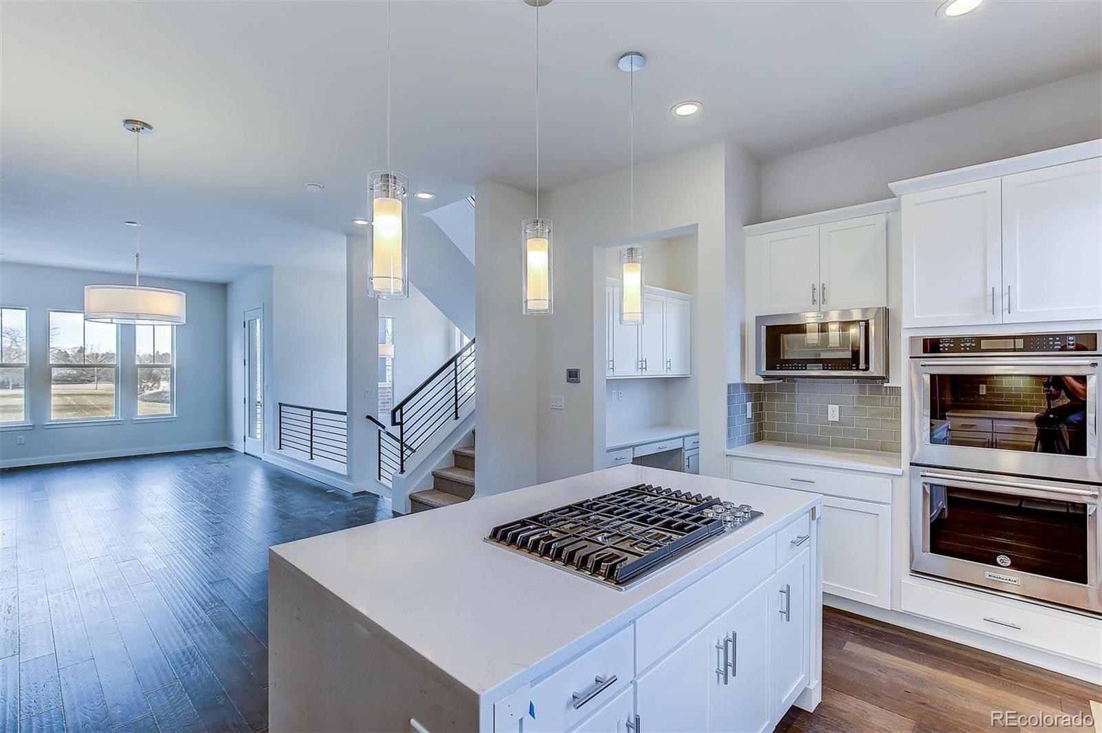 192 South Locust Street Denver, CO 80224 - Photo 11 of 18 a kitchen with wooden floor and a stove top oven