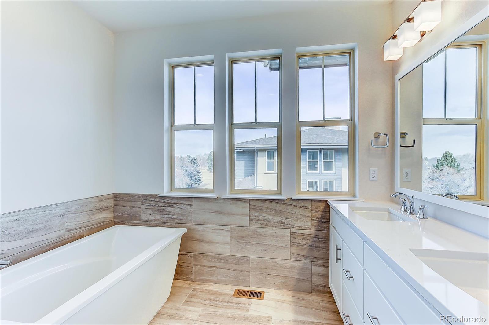 192 South Locust Street Denver, CO 80224 - Photo 13 of 18 a bathroom with a bathtub and a sink