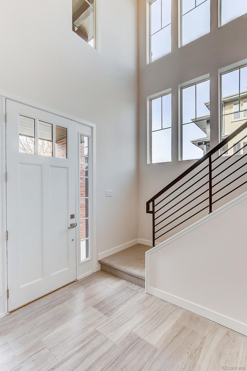 192 South Locust Street Denver, CO 80224 - Photo 7 of 18 an empty room with wooden floor and windows