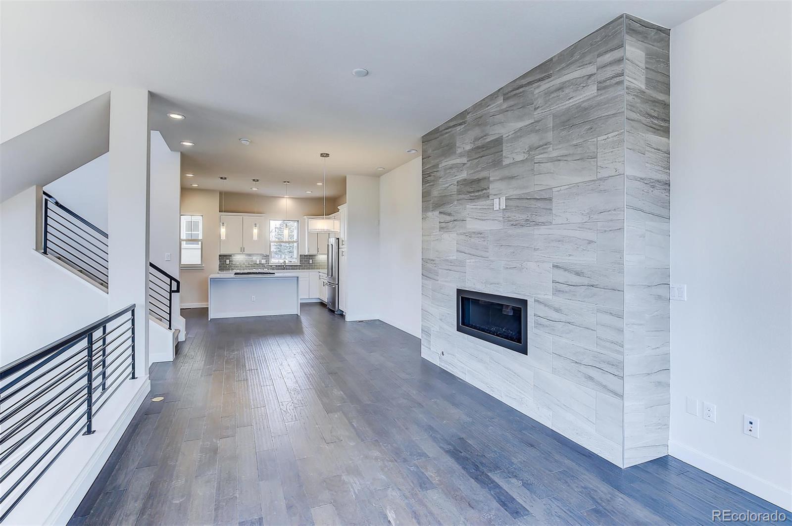192 South Locust Street Denver, CO 80224 - Photo 8 of 18 a view of a kitchen cabinets wooden floor and a fireplace