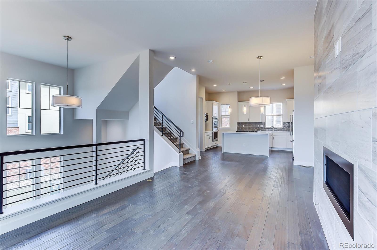 192 South Locust Street Denver, CO 80224 - Photo 9 of 18 a view of a kitchen with wooden floor and a sink