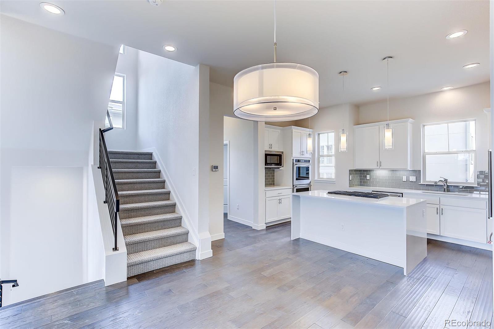 192 South Locust Street Denver, CO 80224 - Photo 10 of 18 a view of a kitchen with cabinets and wooden floor