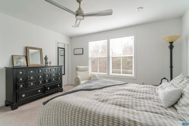a bedroom with a bed window and a dresser