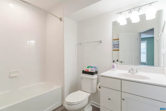 a bedroom with furniture and a large window