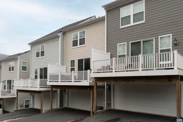 a front view of a residential apartment building with a yard