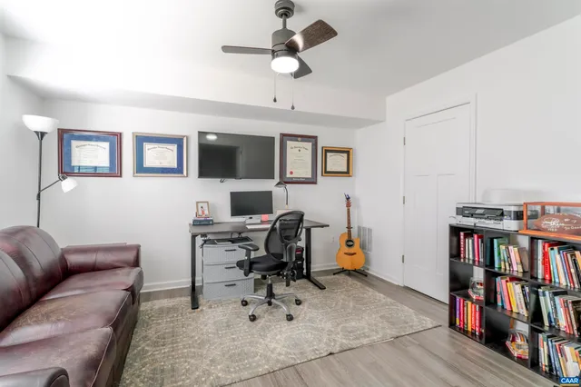 a view of a livingroom with furniture and a book shelf