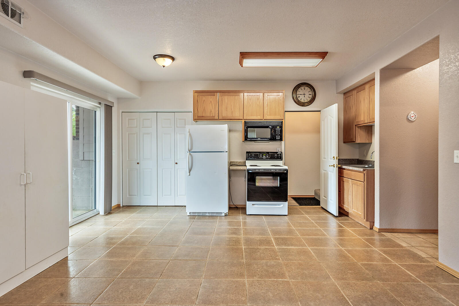 9996 Blackwell Road Central Point, OR 97502 - Photo 22 of 46 a kitchen with granite countertop a refrigerator and a stove top oven