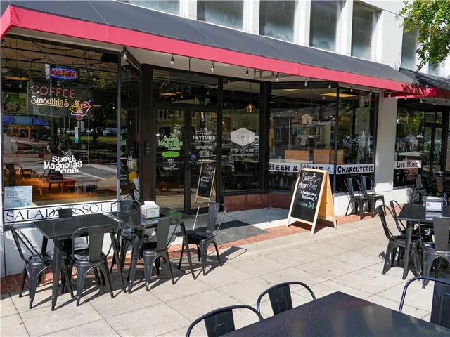 a view of a chairs and table in front of shop
