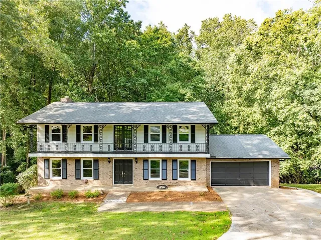 a front view of a house with a yard table and chairs