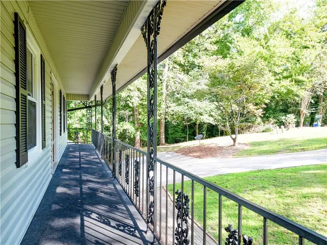 a view of a balcony with floor to ceiling windows and wooden fence