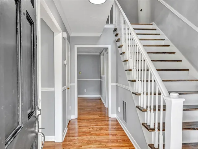 a view of a hallway with wooden floor and entryway