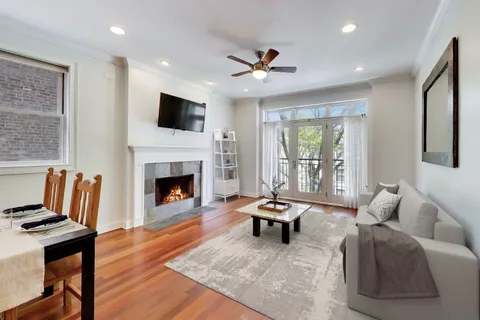 a living room with furniture fireplace and flat screen tv