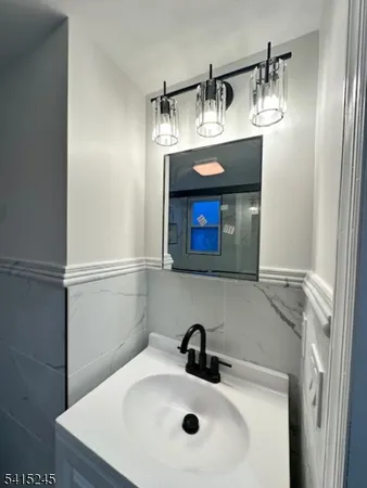 a bathroom with a sink a toilet and mirror