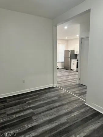a open kitchen with kitchen island white cabinets and stainless steel appliances