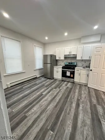 a kitchen with a white cabinets and white appliances