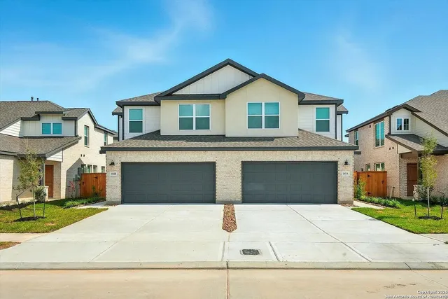 a front view of a house with garage