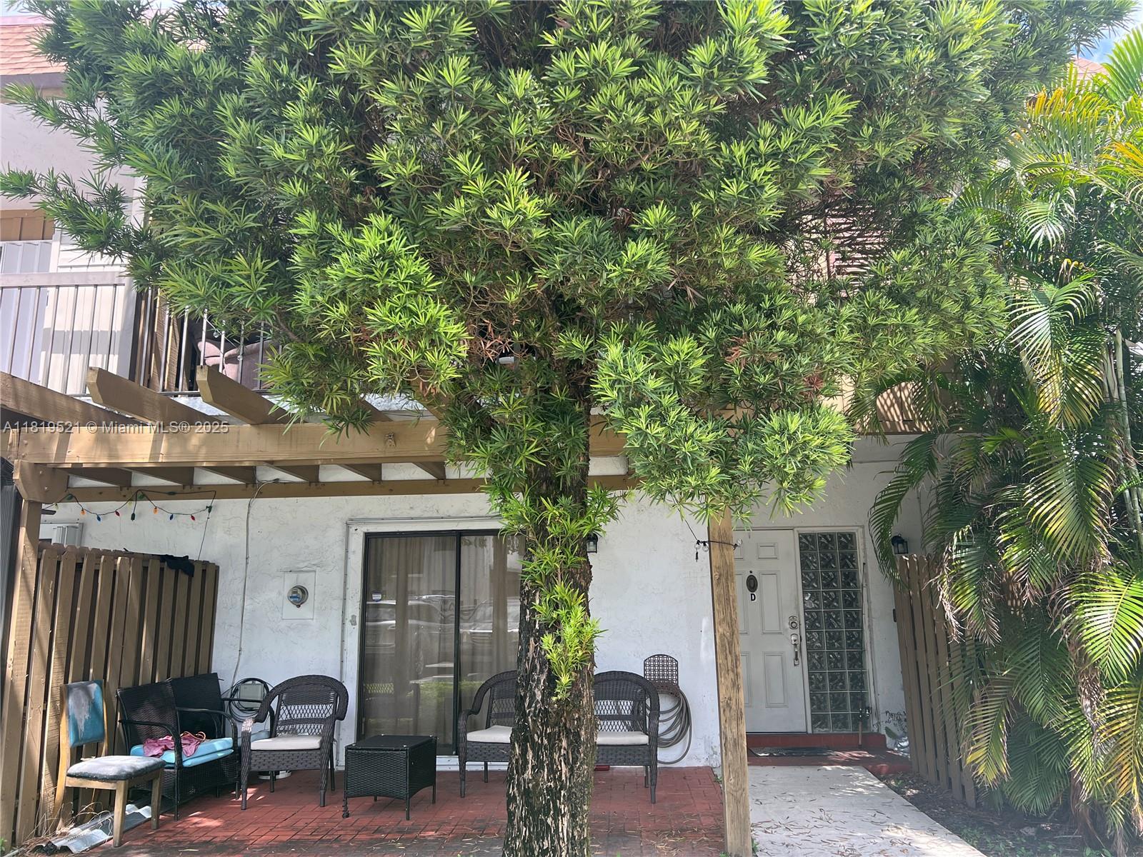 6885 Northwest 169th Street, Unit 66D Hialeah, FL 33015 - Photo 1 of 3 a front view of a house with patio