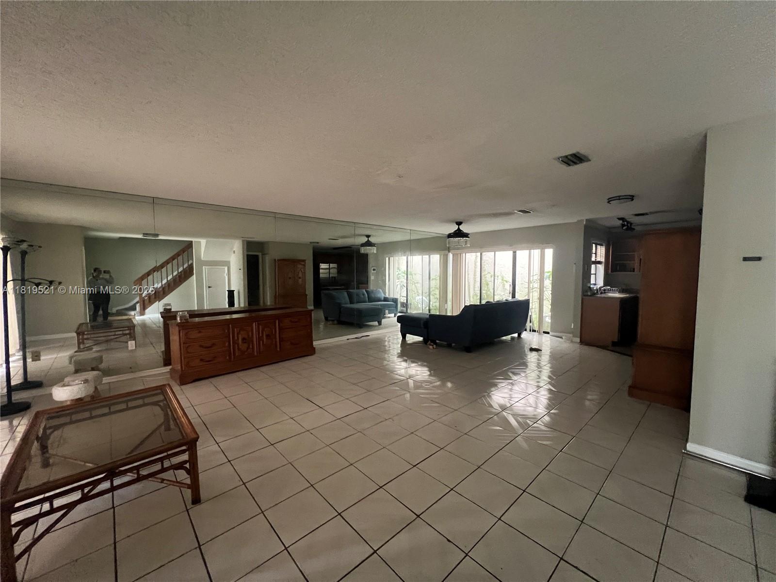 6885 Northwest 169th Street, Unit 66D Hialeah, FL 33015 - Photo 3 of 3 a view of living room and kitchen with furniture