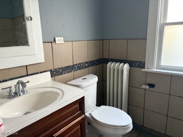 3258 Berkshire Road Cleveland, OH 44118 - Photo 19 of 23 Bathroom featuring tile walls, vanity, radiator, and a wainscoted wall