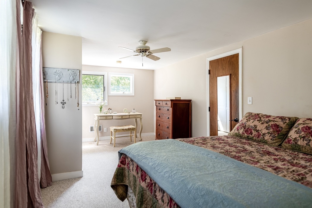 51 Turkey Shore Road Ipswich, MA 01938 - Photo 16 of 23 a bedroom with a bed and dresser with mirror