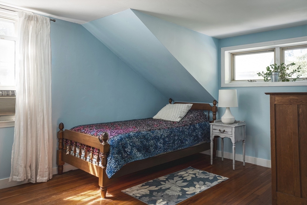 51 Turkey Shore Road Ipswich, MA 01938 - Photo 17 of 23 a bedroom with a bed and wooden floor