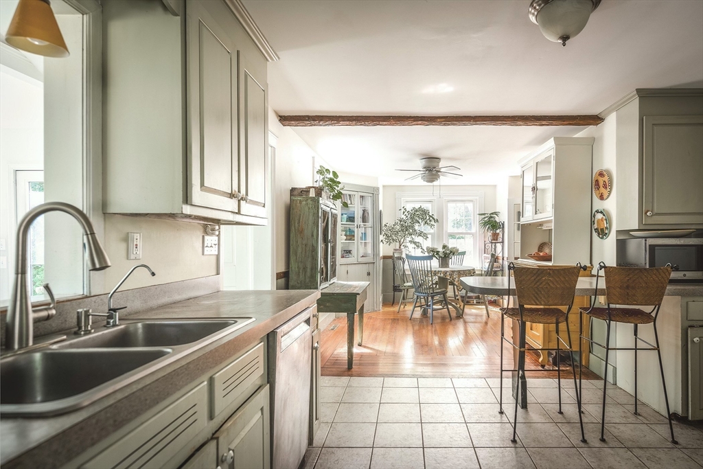 51 Turkey Shore Road Ipswich, MA 01938 - Photo 8 of 23 a dining hall with stainless steel appliances a dining table a stove and a view of living room