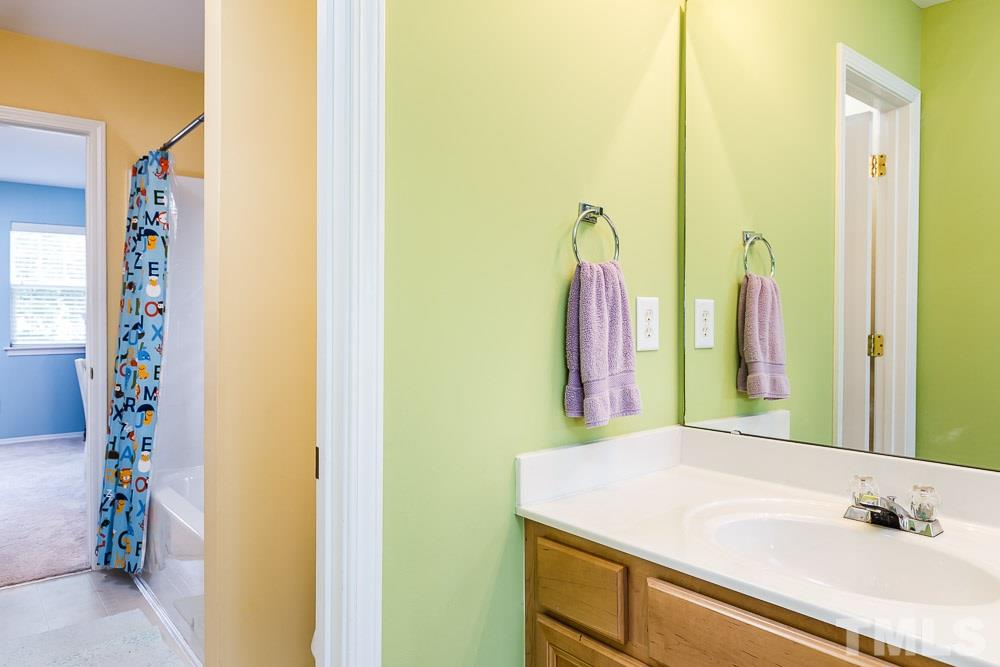 8308 Chimneycap Drive Raleigh, NC 27613 - Photo 14 of 23 Each vanity has ample counter space and storage with private access to the shared wet area!