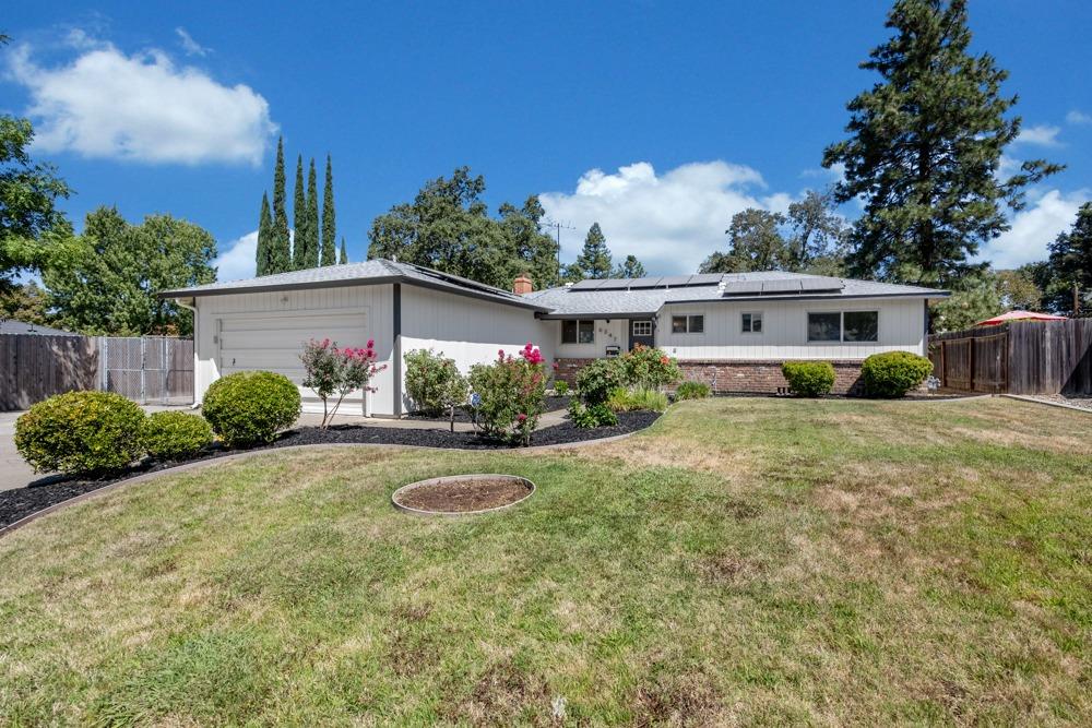 a view of a house with backyard and sitting area