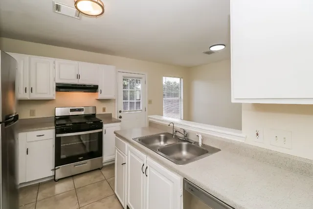 a kitchen that has a sink and a stove